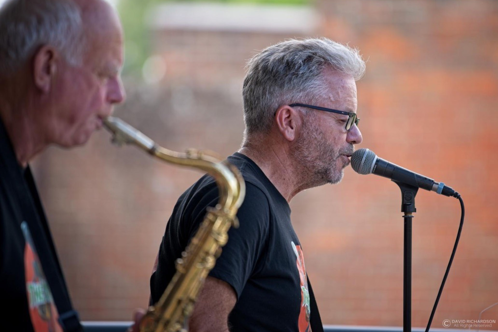 Two band members of the West Sussex band The Martians playing outside.